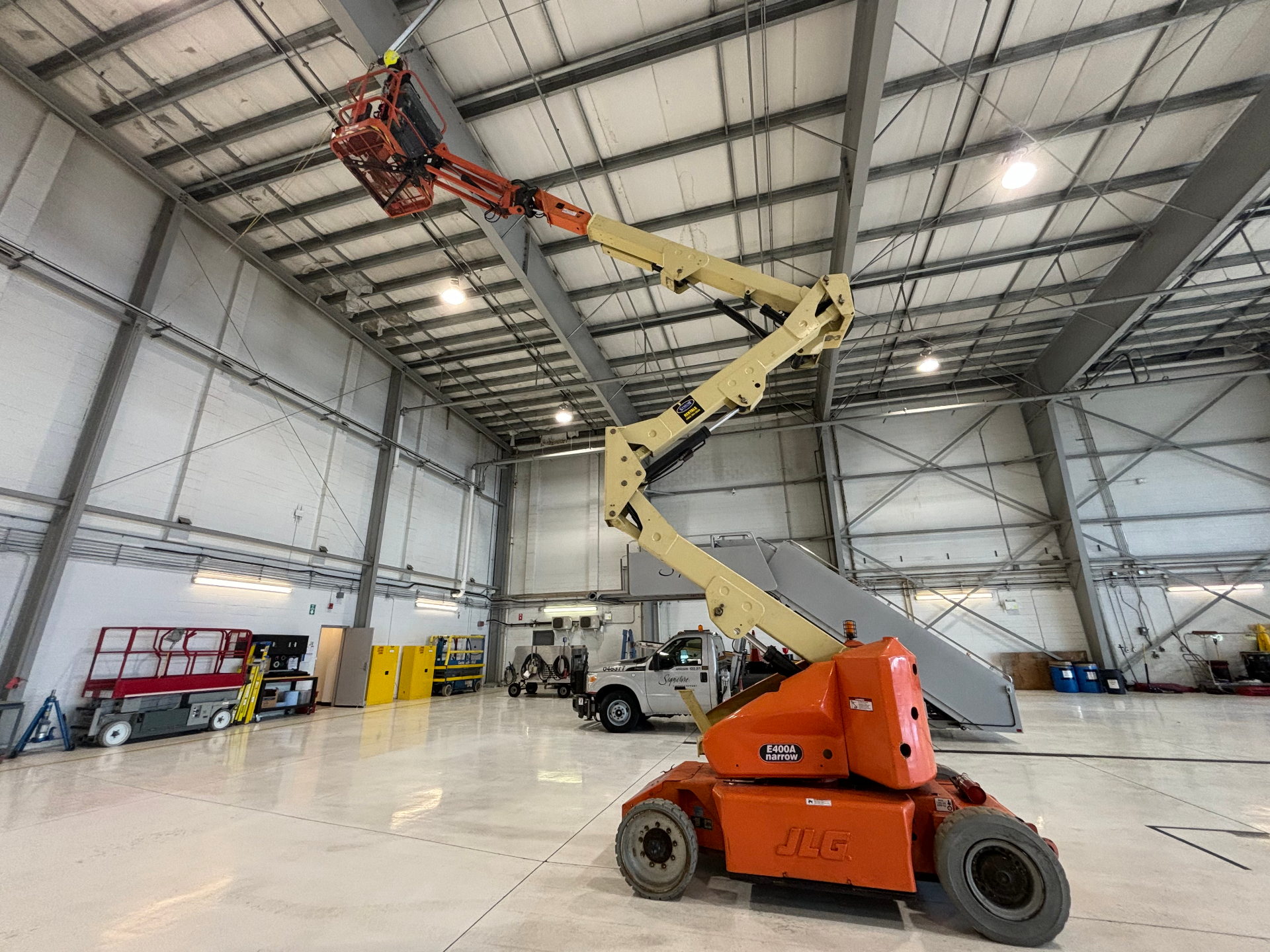 AIM technician working from a boom lift to install a horizontal lifeline on a rooftop